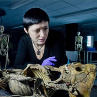 presenter looking at skeleton on History Cold Case