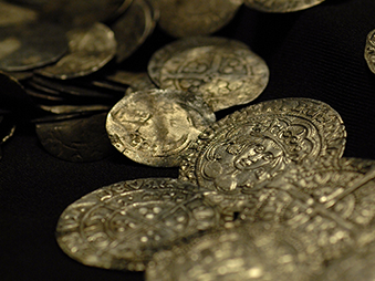 gold coins scattered on black table