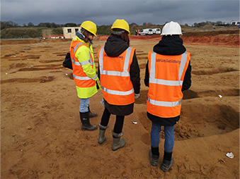 people visiting a commercial excavation site