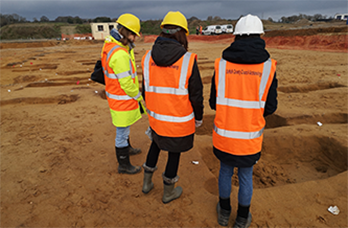 people visiting a commercial excavation site