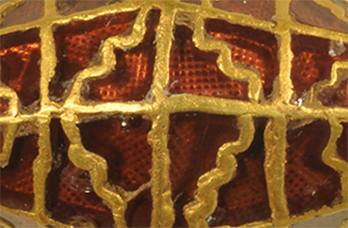 close up image of gold and garnet bead found at Rendlesham