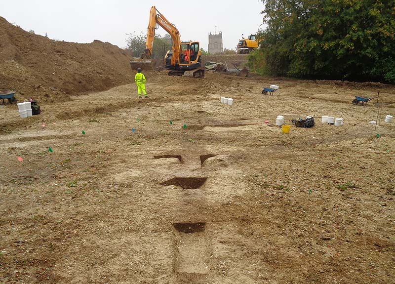 excavation site with digger and people