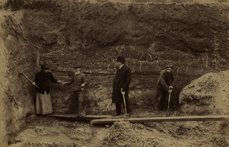 sepia photograph of 4 people excavating a terrace