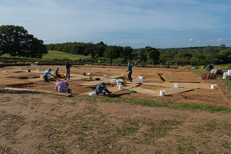 field with people excavating