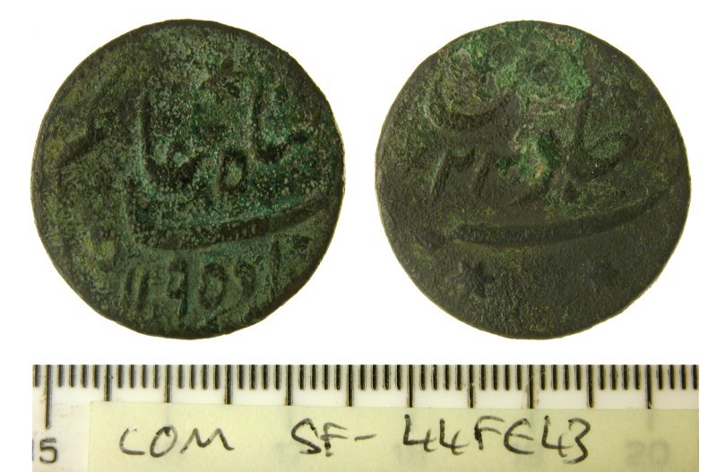 greenish coloured coin front and back