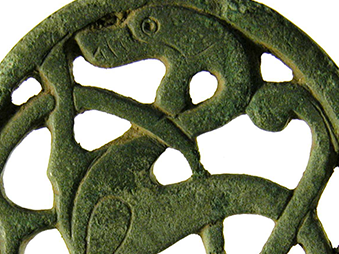 copper alloy mount with openwork decoration depicting an animal