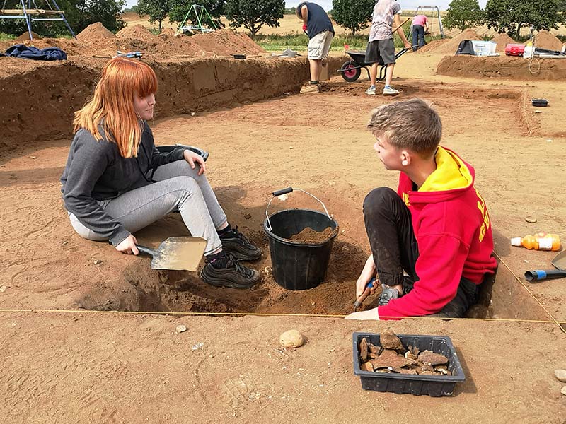 two young people excavating