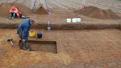 people excavating a sunken-featured building