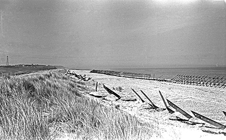 black and white photo of beach scaffolding