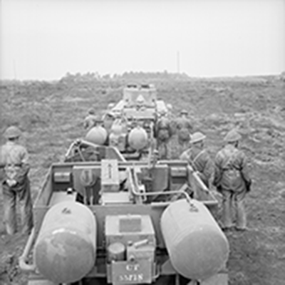 war photo of soldiers with explosives lined up for drills